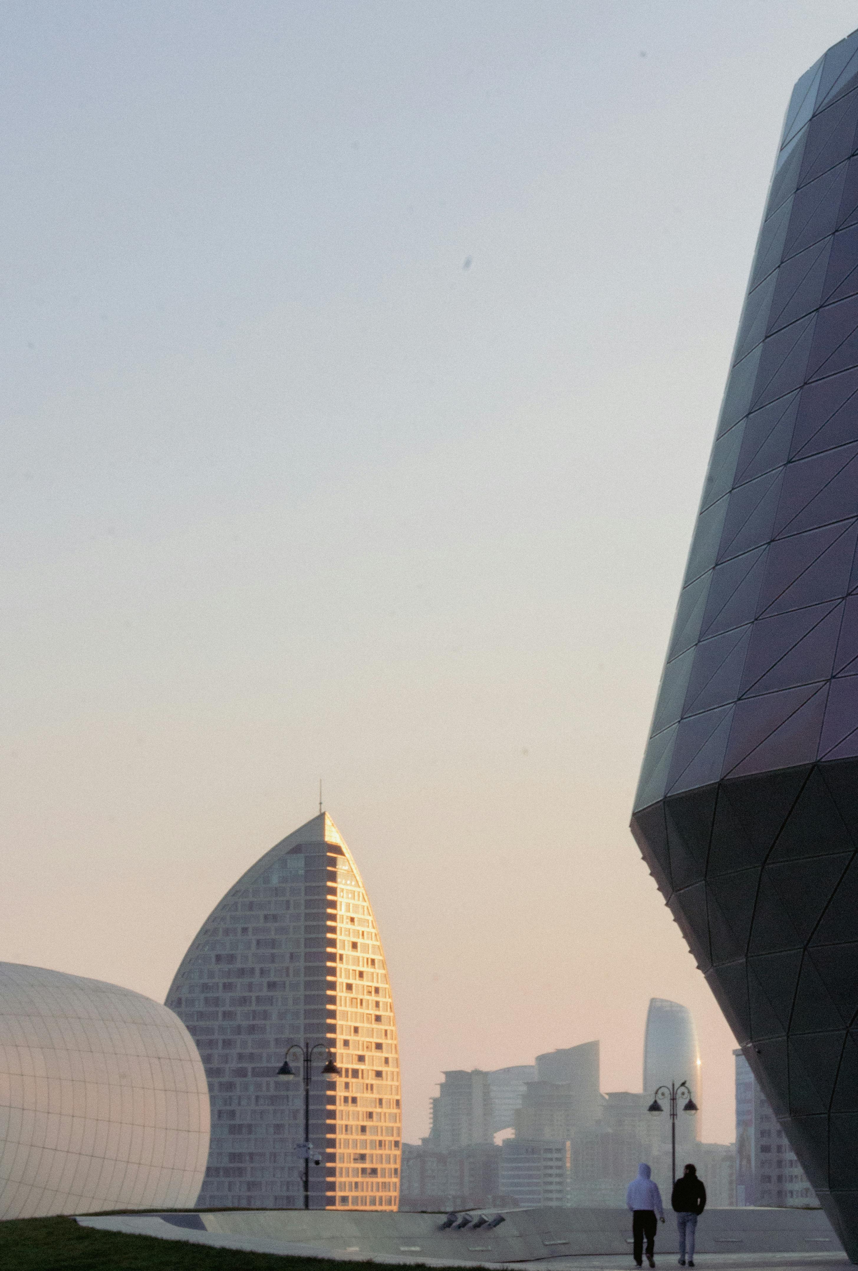 Contemporary architecture in urban skyline at sunset with iconic buildings.