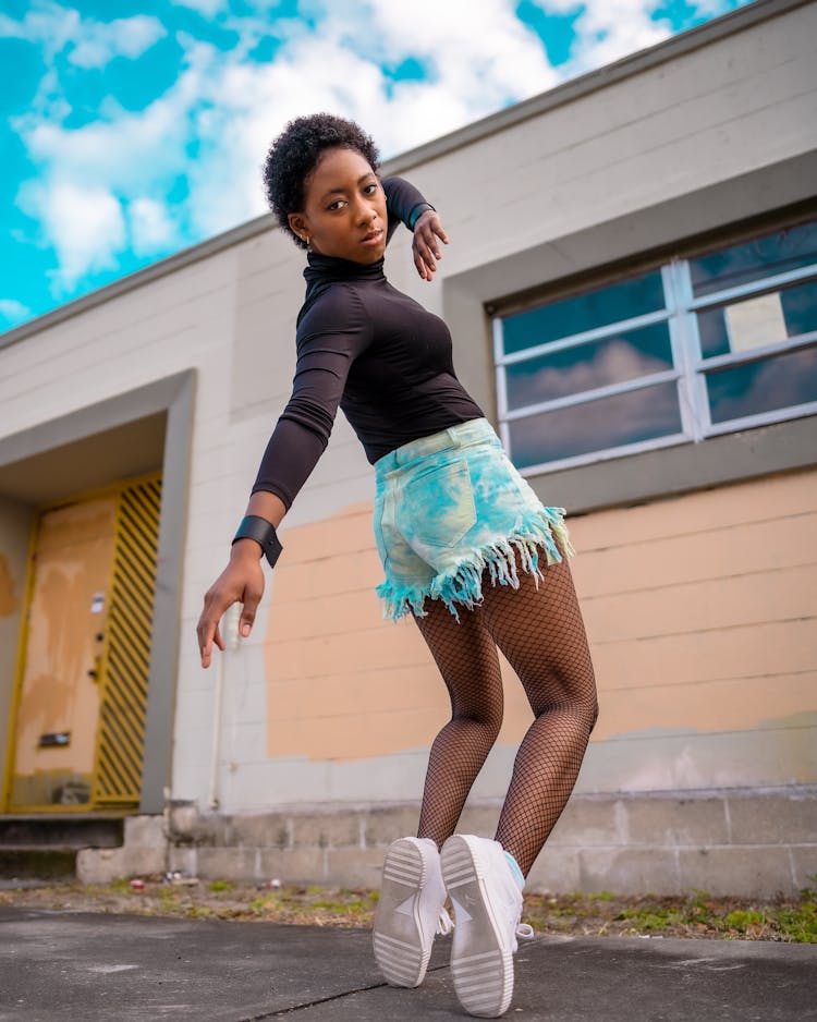 Woman In Shorts Dancing On Street