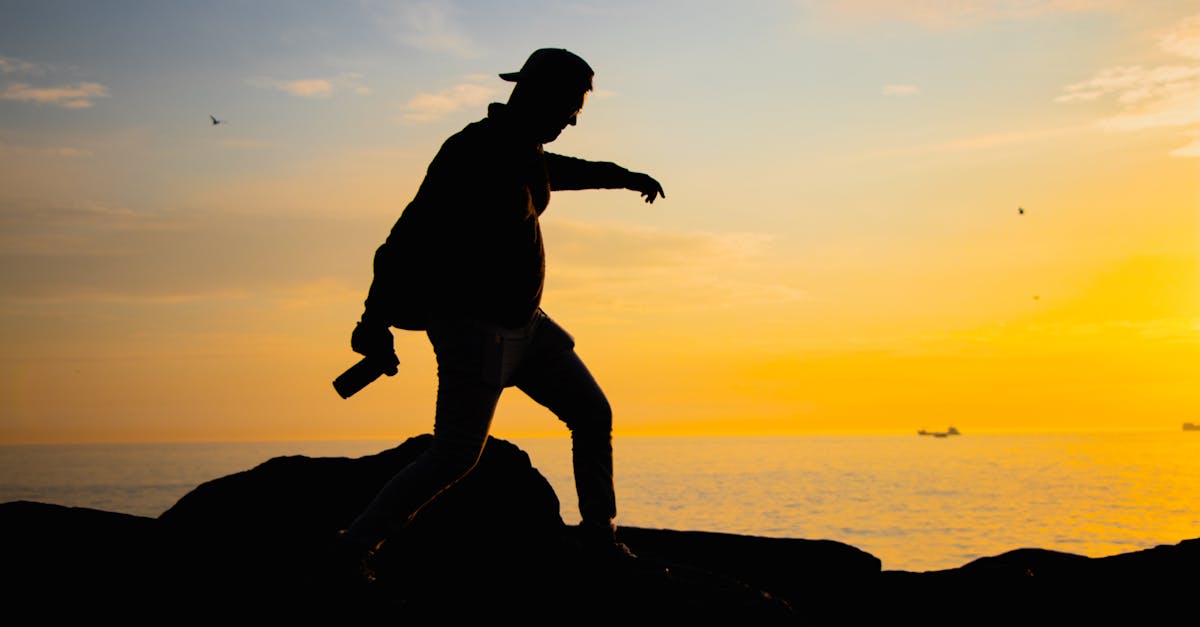 Man on Rocks at Sunset · Free Stock Photo