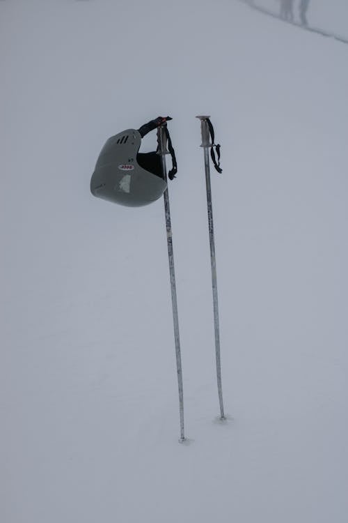 Ski Poles and a Helmet in Snow 