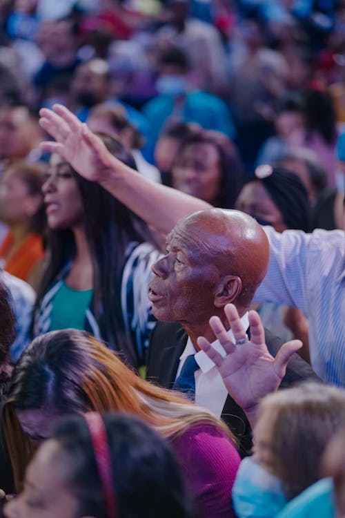 Crowd Praying at Gathering on Stadium