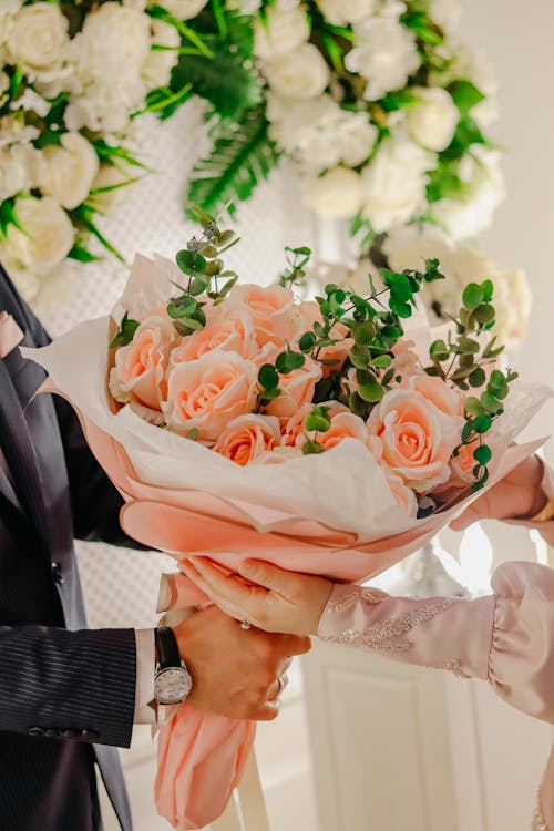 Bride and Groom Holding Bouquet at Wedding Ceremony