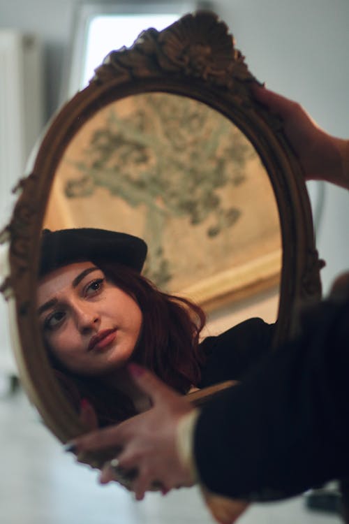 Woman Face Reflection in Decorated Mirror