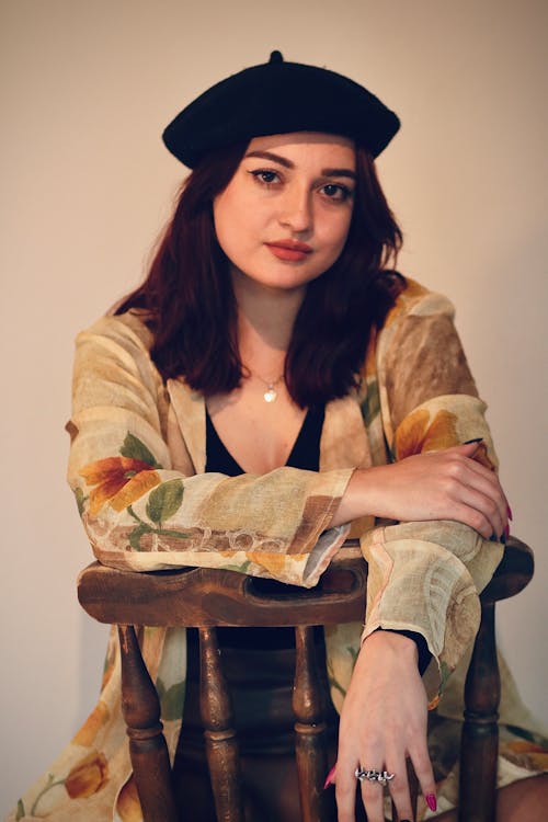 Young Woman in Beret Sitting on Chair