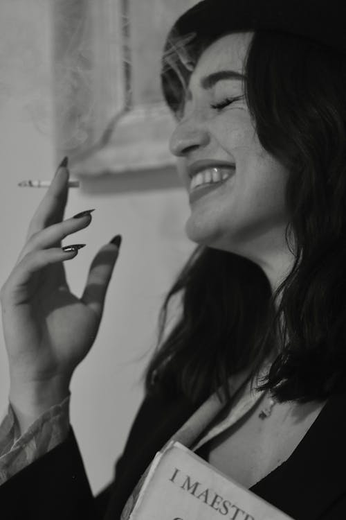 Young Woman Laughing and Smoking a Cigarette 
