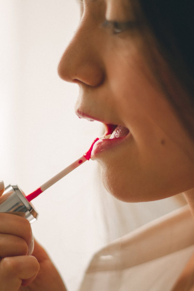 Woman Applying Lipstick