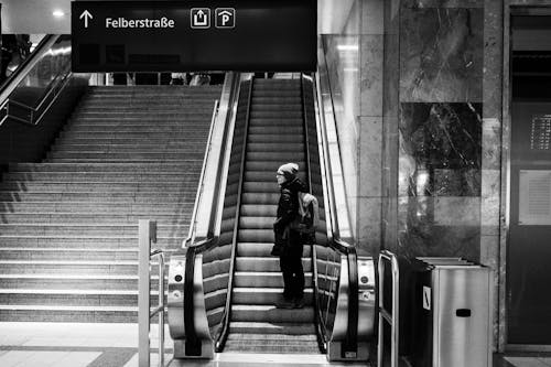 Woman Riding on Escalator on Railway Station