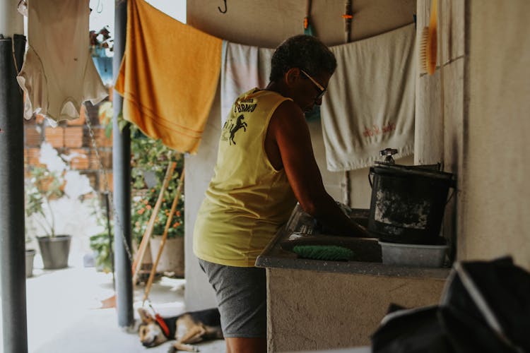 Woman Washing In Sink Outdoors