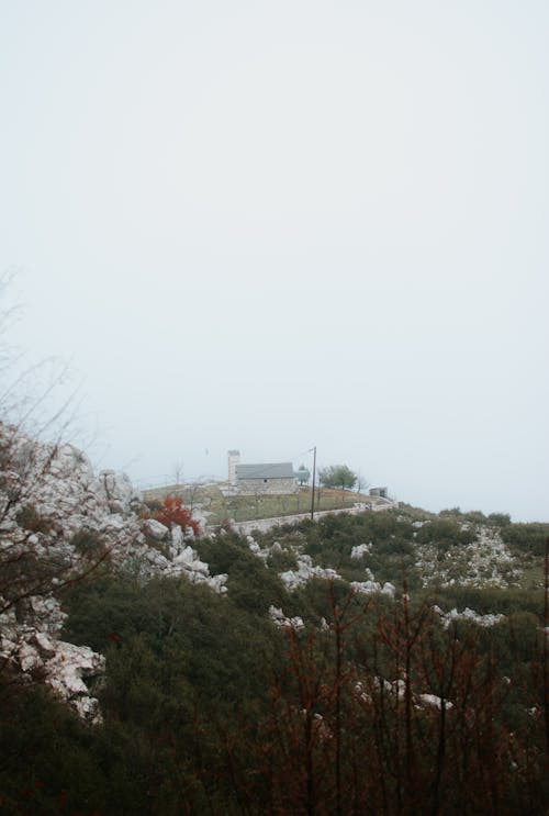 Hut in a Mountain Valley Covered with Fog 