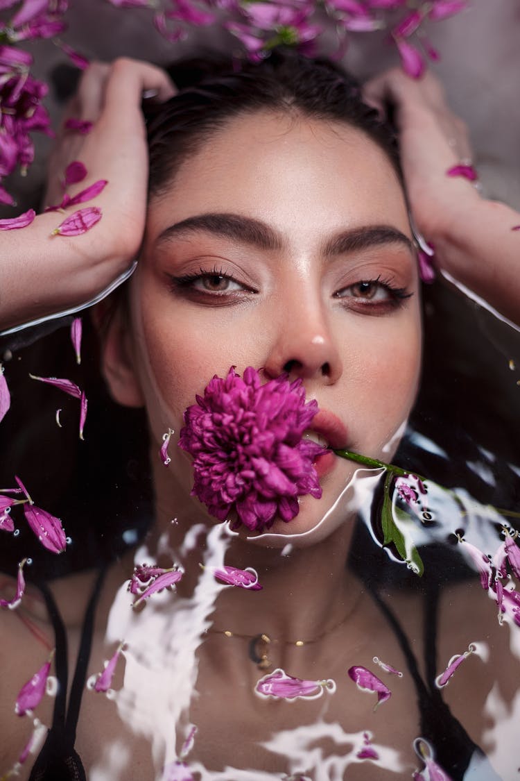 Beautiful Woman With Flower In Water