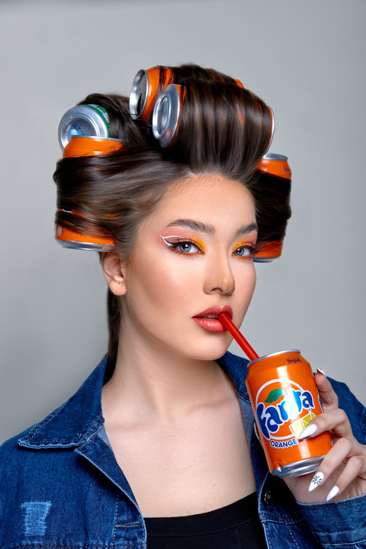 Young Woman Drinking Soda Form Can