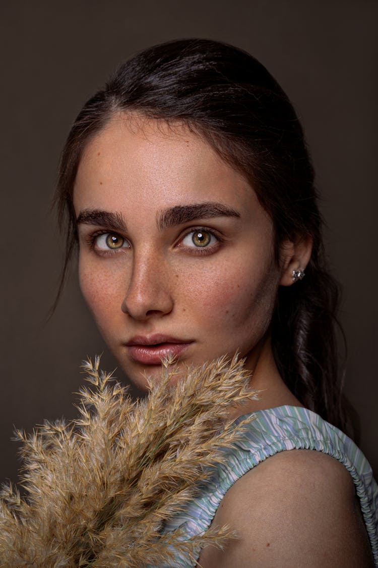 Portrait Of Beautiful Woman With Dry Grass