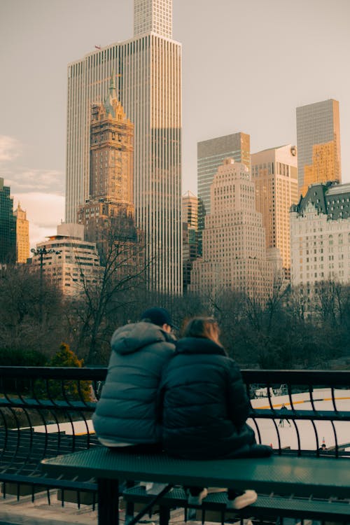 Free Woman and Man Sitting in Central Park Stock Photo