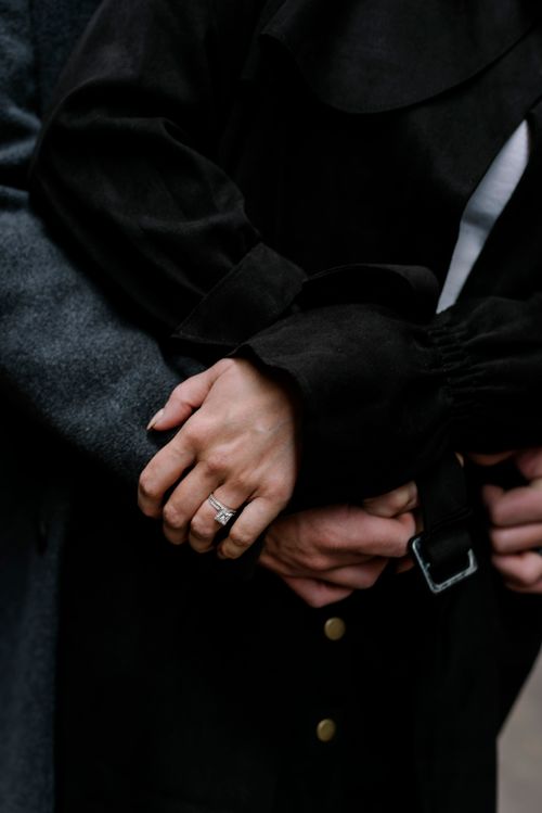 Free Intimate close-up of a couple embracing, showcasing an engagement ring in focus. Stock Photo
