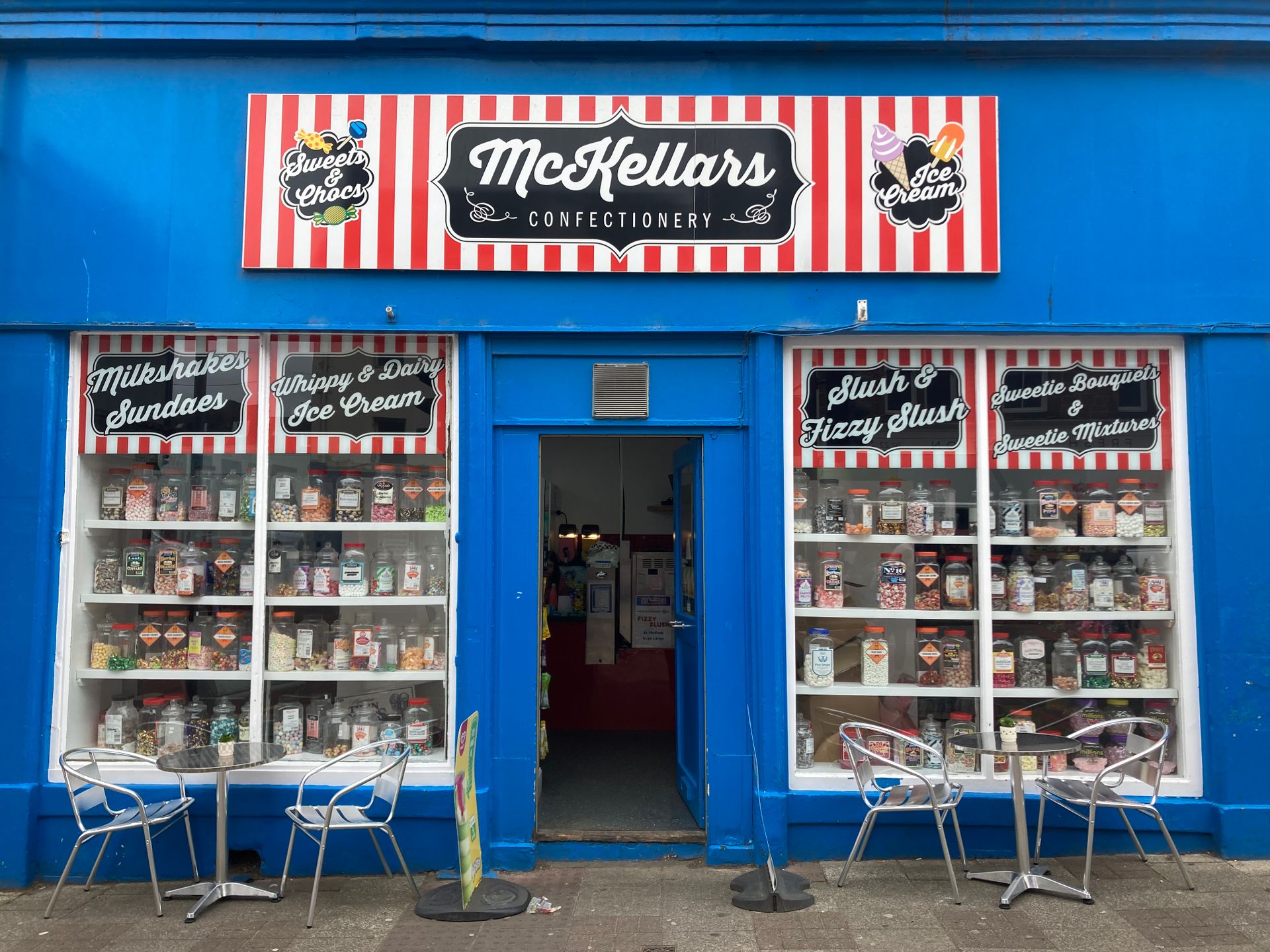 Vibrant candy shop entryway with sweet treats on display.