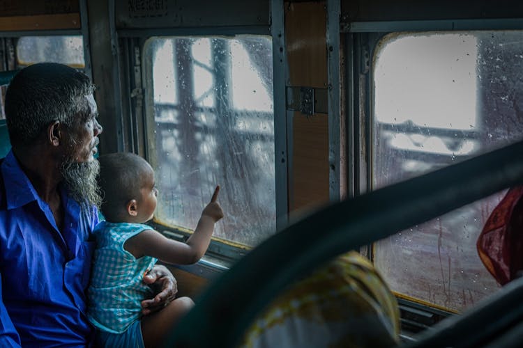 A Man With Child Sitting In The Bus