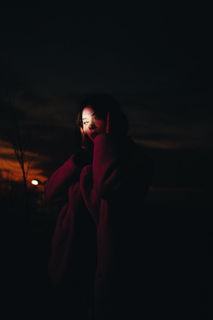 Woman In Coat At Night