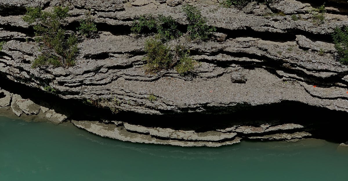 Uneven Rock Formation near Body of Water · Free Stock Photo