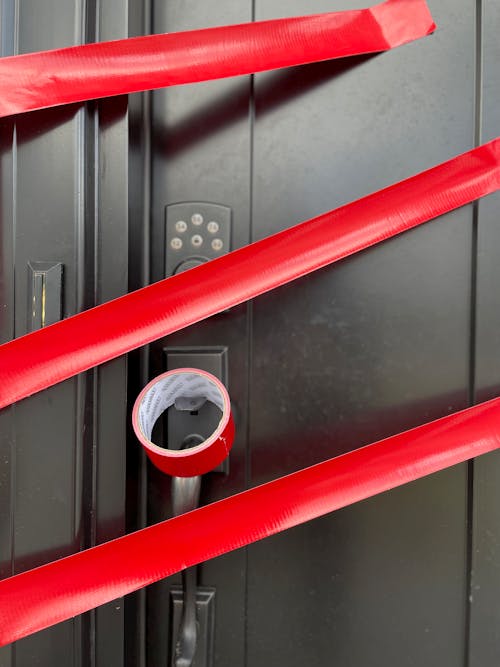 Red Adhesive Tape on Metal Door