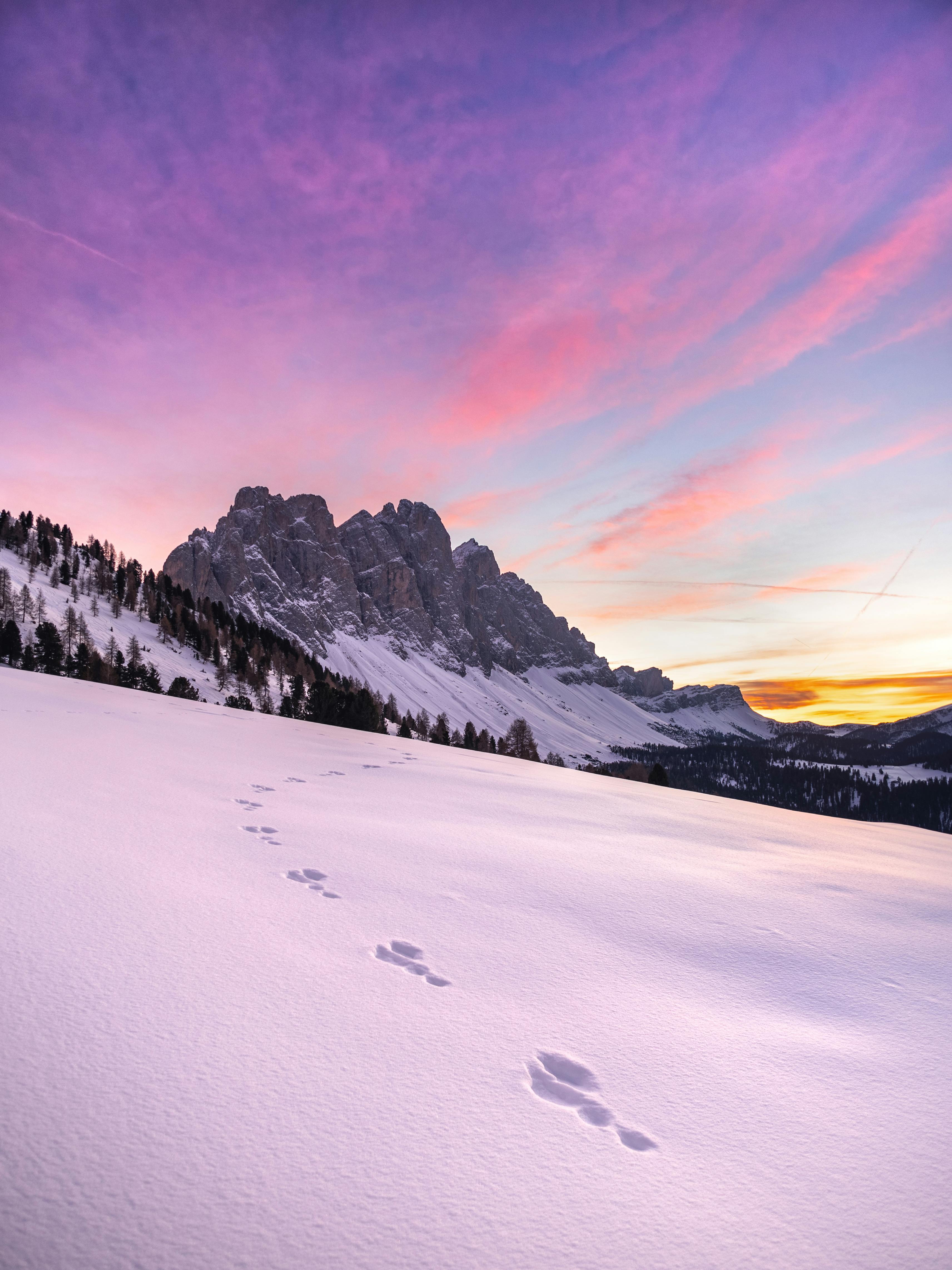 Footprints in the snow at sunset in the dolomites · Free Stock Photo
