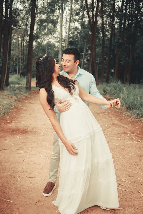 Couple Hugging on Dirt Road in Forest