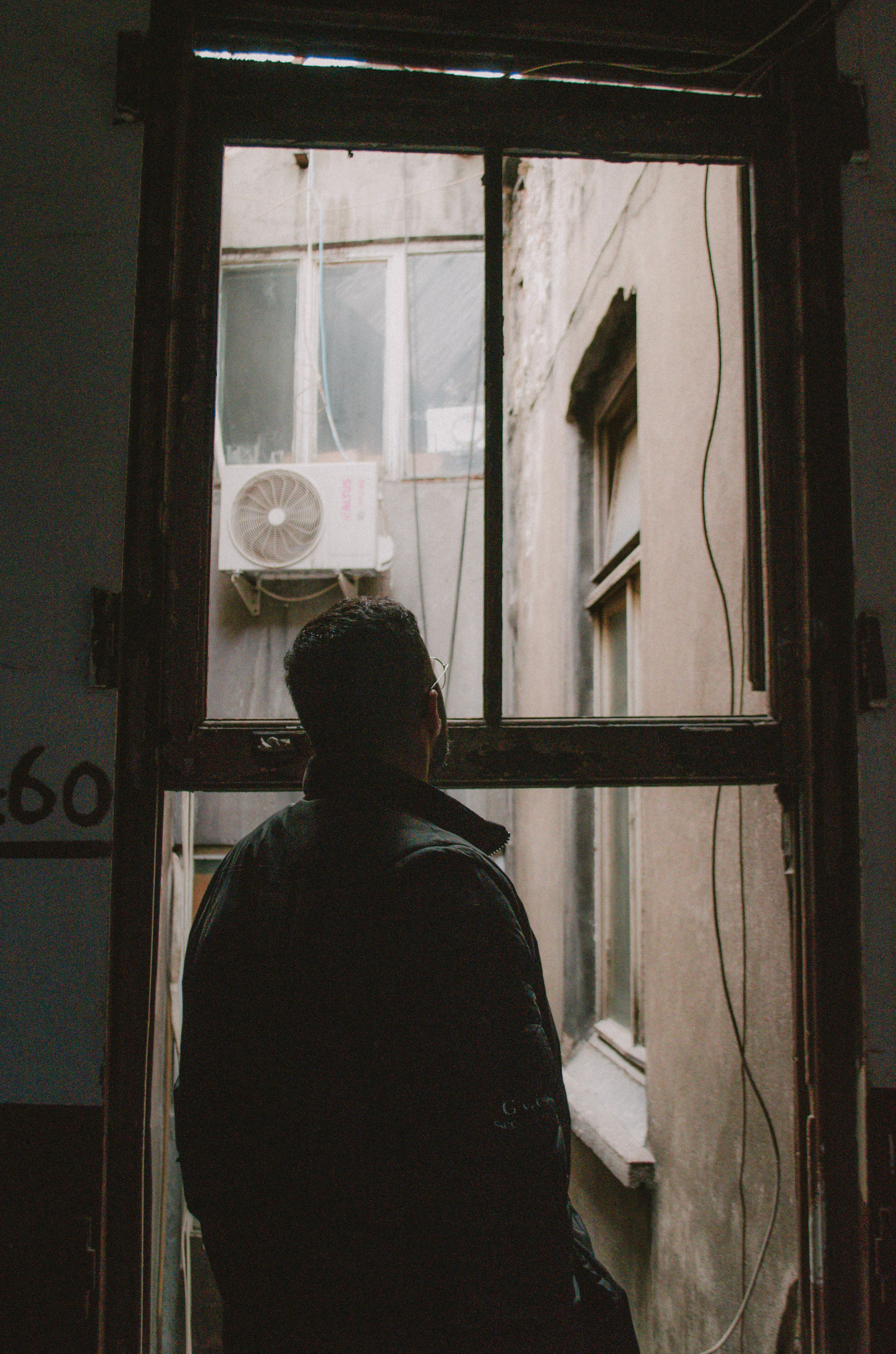 Man In A Window Man Standing and Looking through the Window · Free Stock Photo