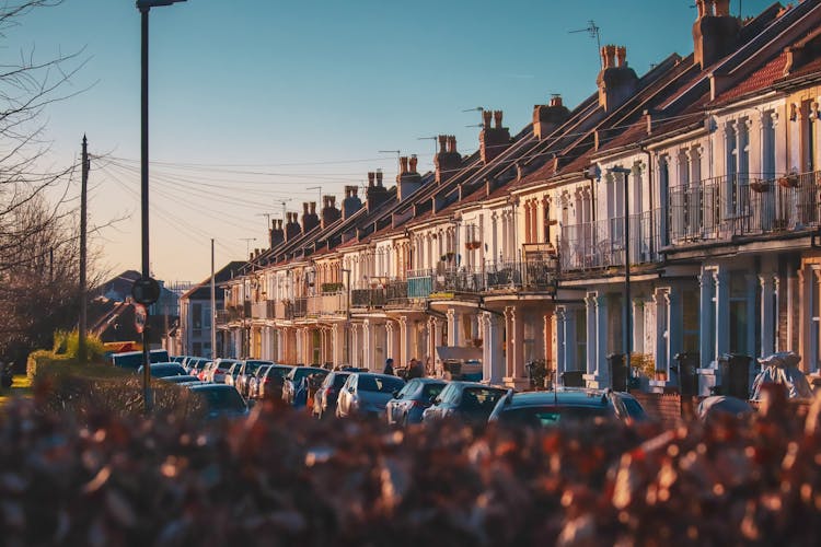 Townhouses And A Street With Parked Cars