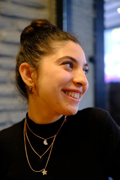 Smiling Brunette Wearing Gold Necklaces