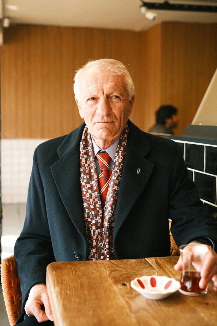 Old Man Drinking Tea In Cafe