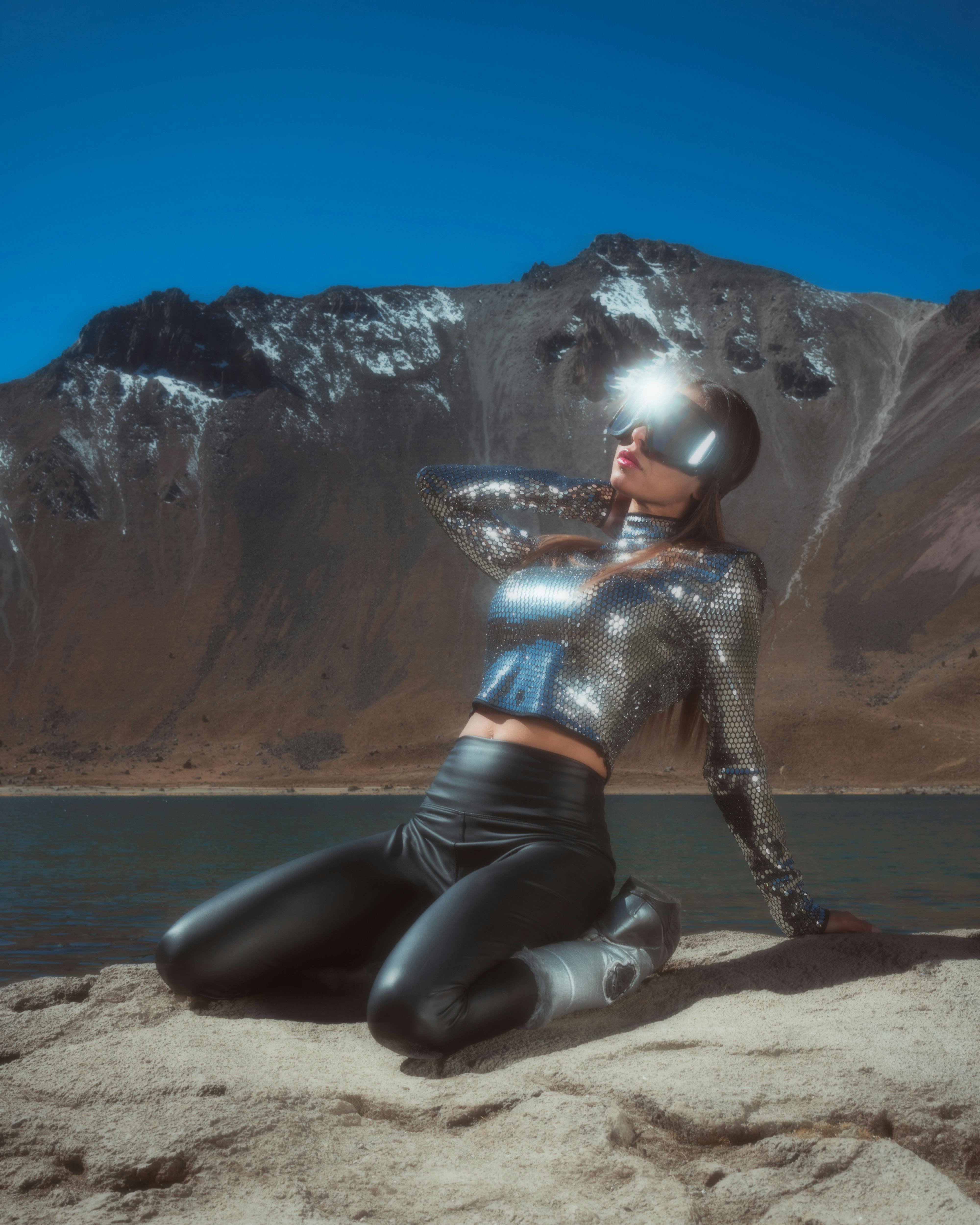 woman in metallic outfit kneeling on the ground