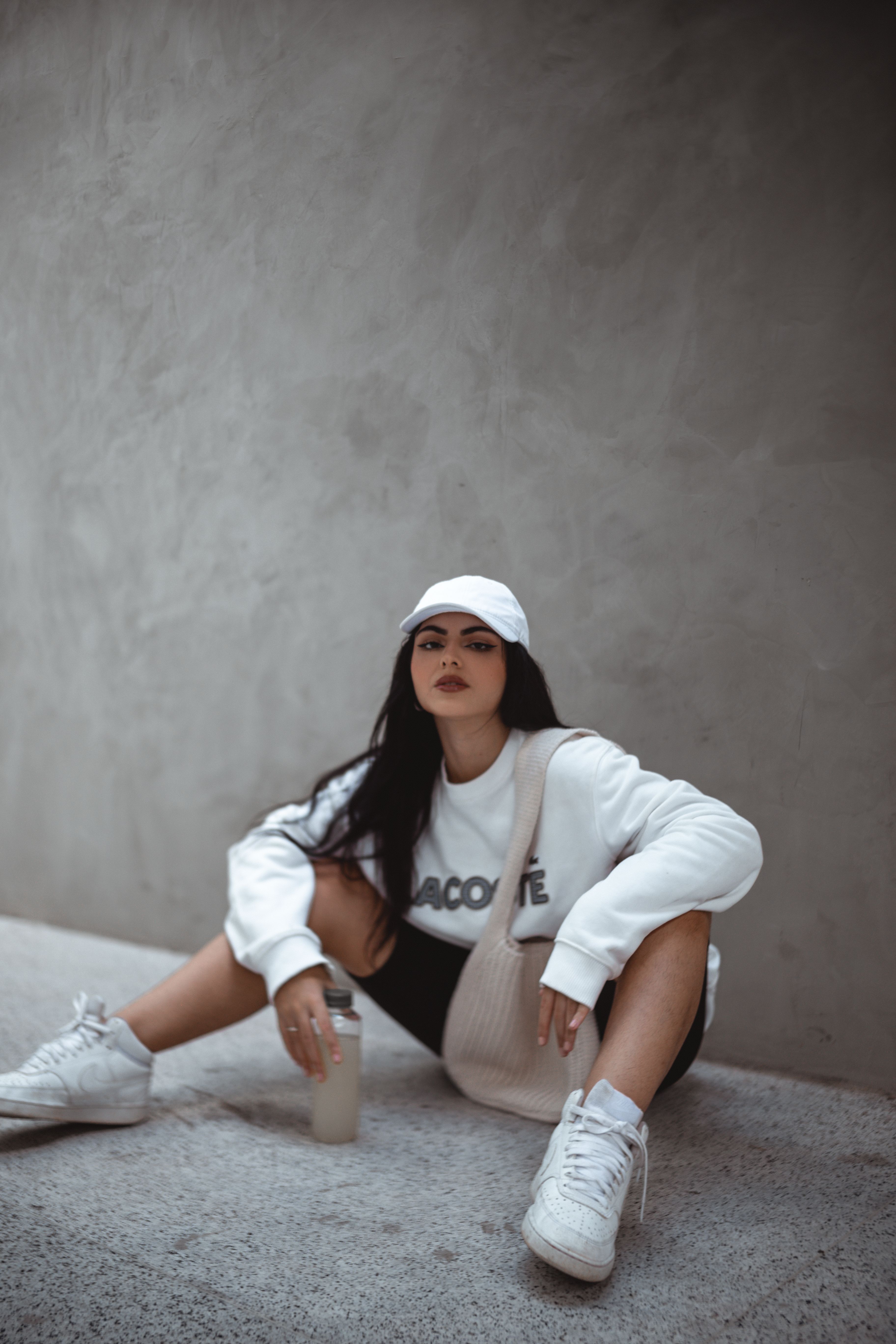 Woman Wearing a White Sweater Sitting on the Floor · Free Stock Photo