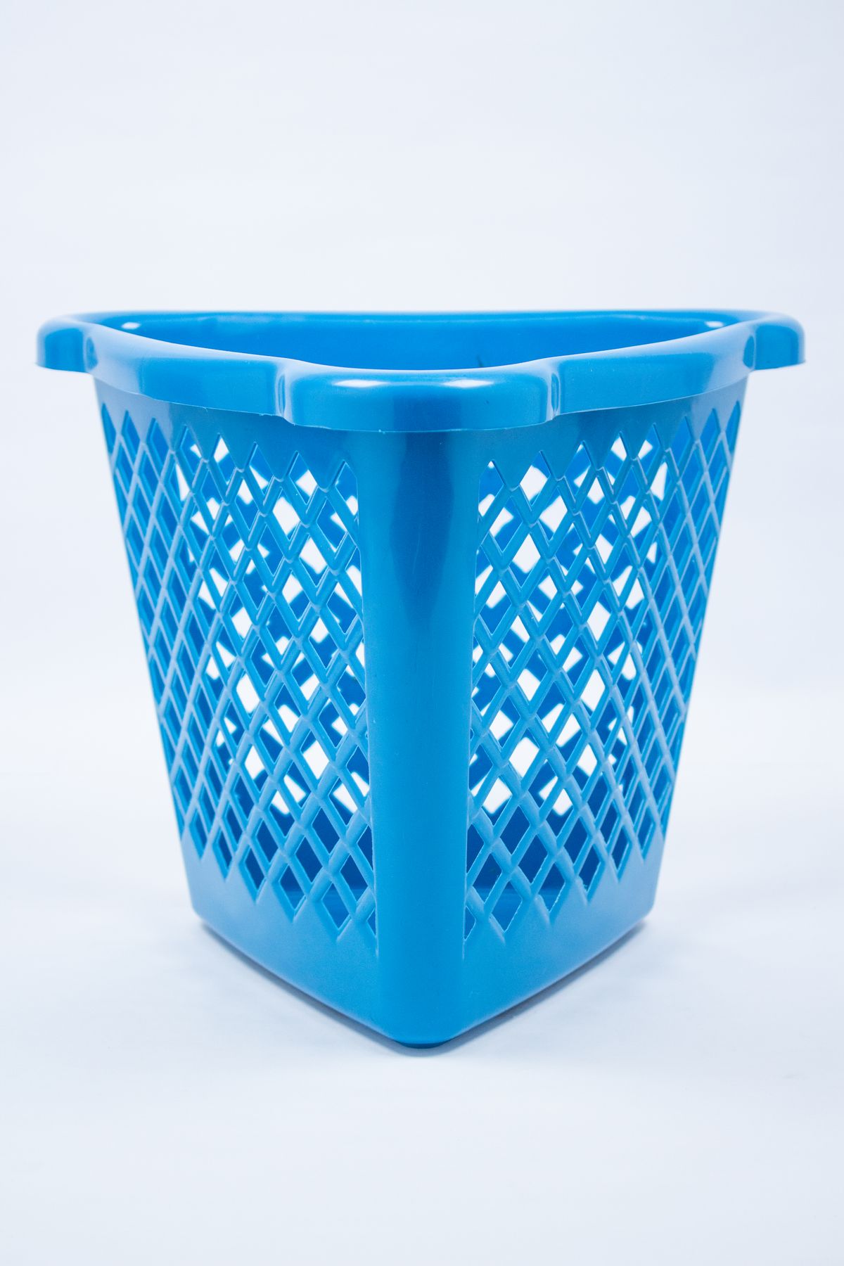 Close-up of a simple blue plastic laundry basket against a clean white background