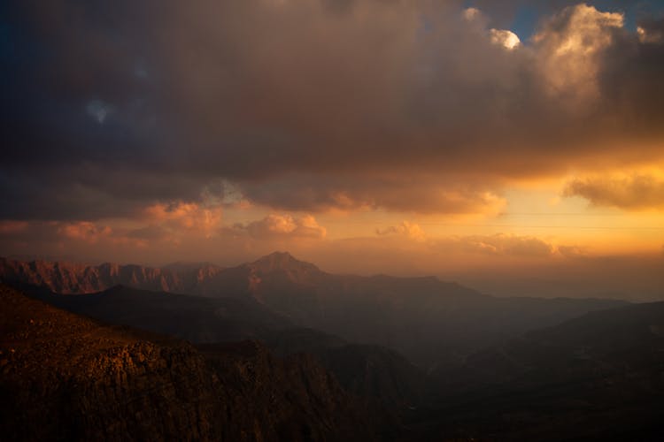 Clouds Over Mountains At Sunset