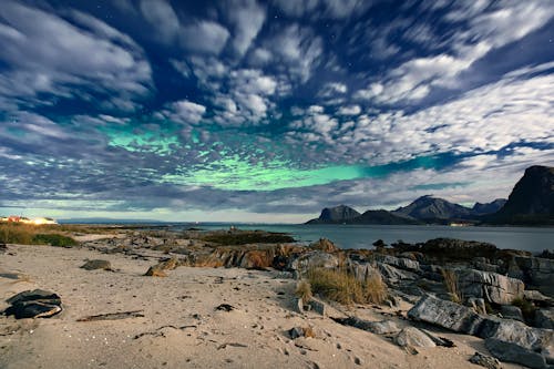 View of Northern Lights over a Sea in Daylight 