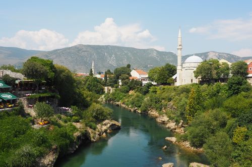 Free Stunning aerial view of Neretva River with the historic Koski Mehmed Pasha Mosque in Mostar, Bosnia and Herzegovina. Stock Photo