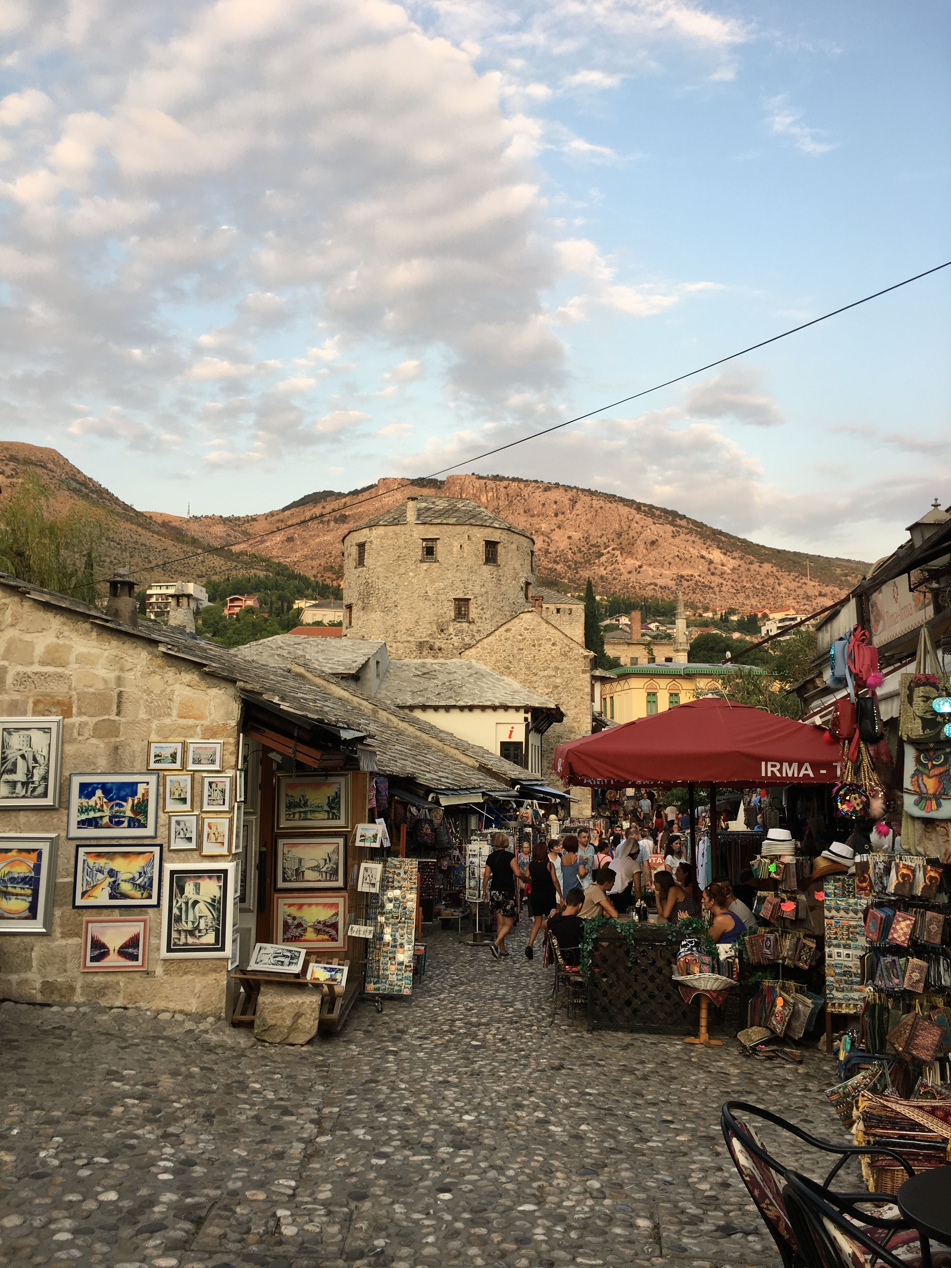 Charming street market in Mostar's Old Town, featuring cobblestone pathways and historic architecture.