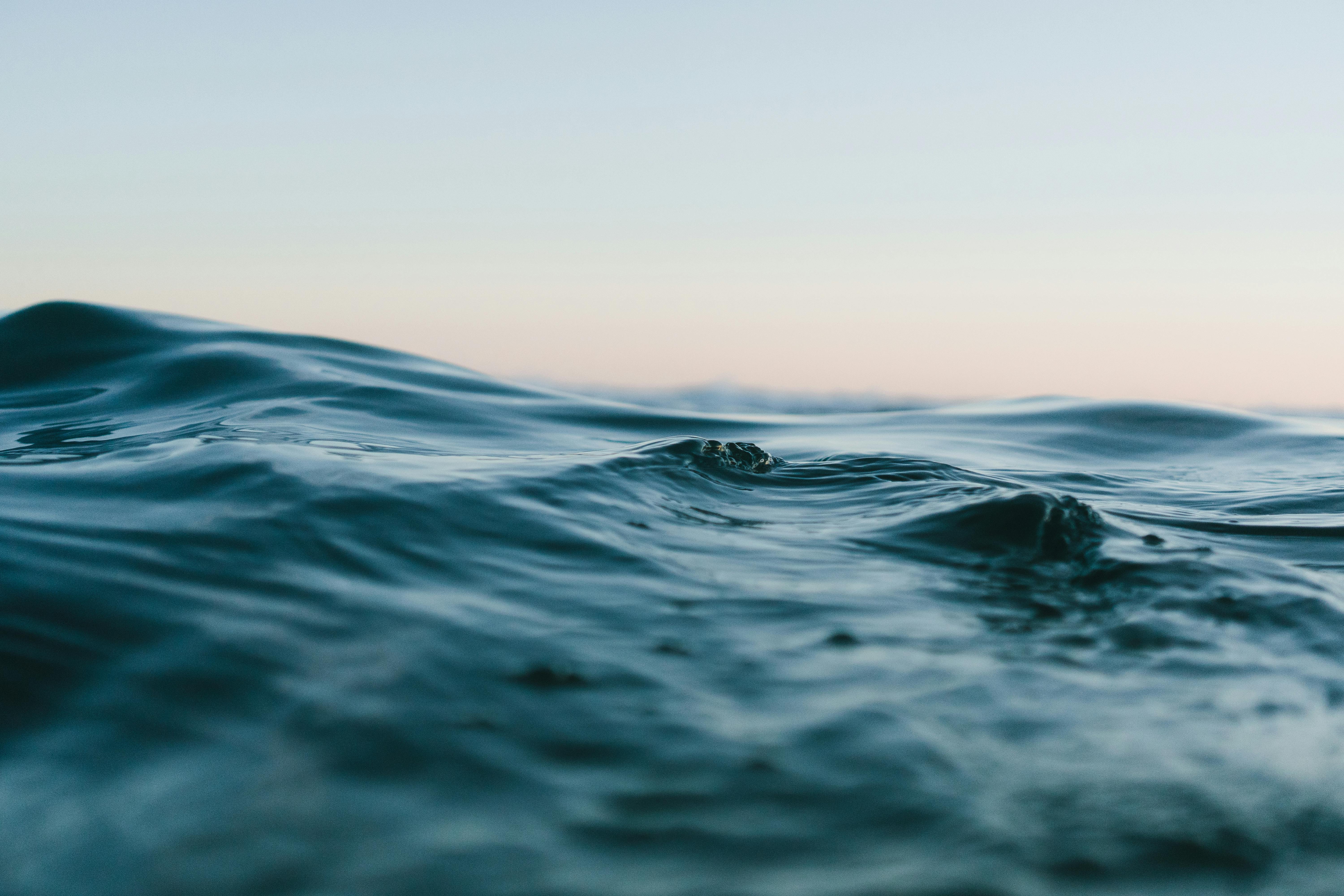 body of water under blue and white skies