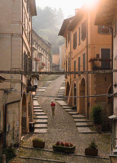 A captivating European street scene with cobblestone pavement, historic buildings, and a lone traveler, perfect for travel inspiration.