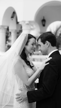 Elegant black and white photo capturing a couple's intimate moment during their wedding in Tulum, Mexico.