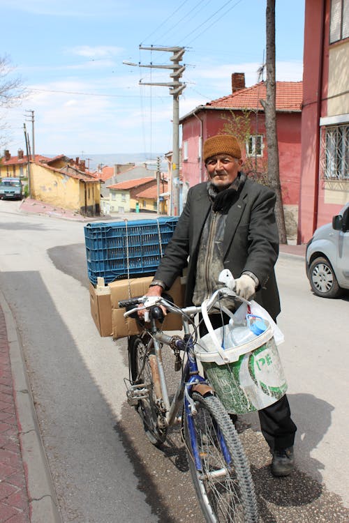 Man with Loaded Bicycle on Street