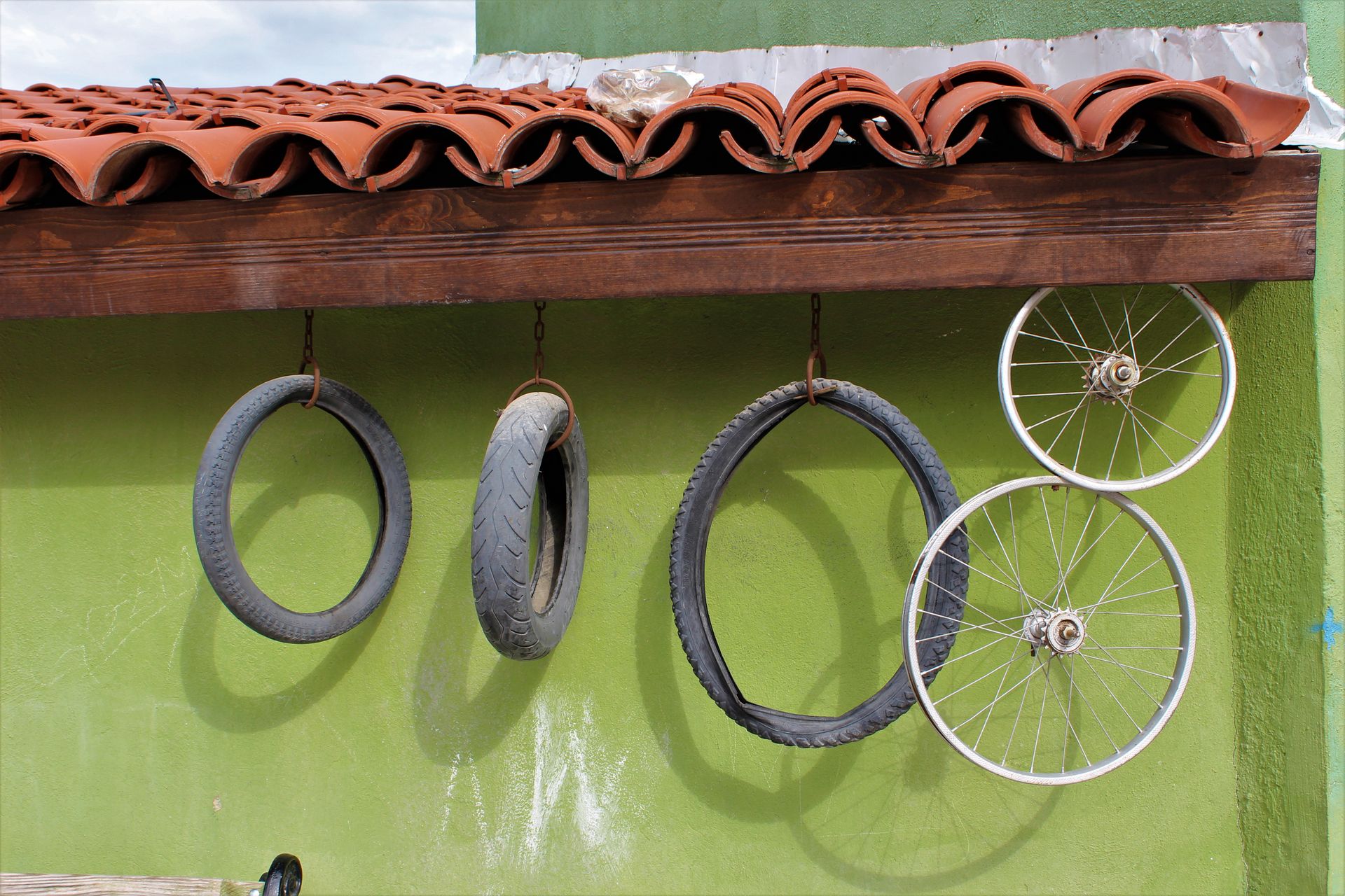 Tyres and Wheels Hanging on Wall