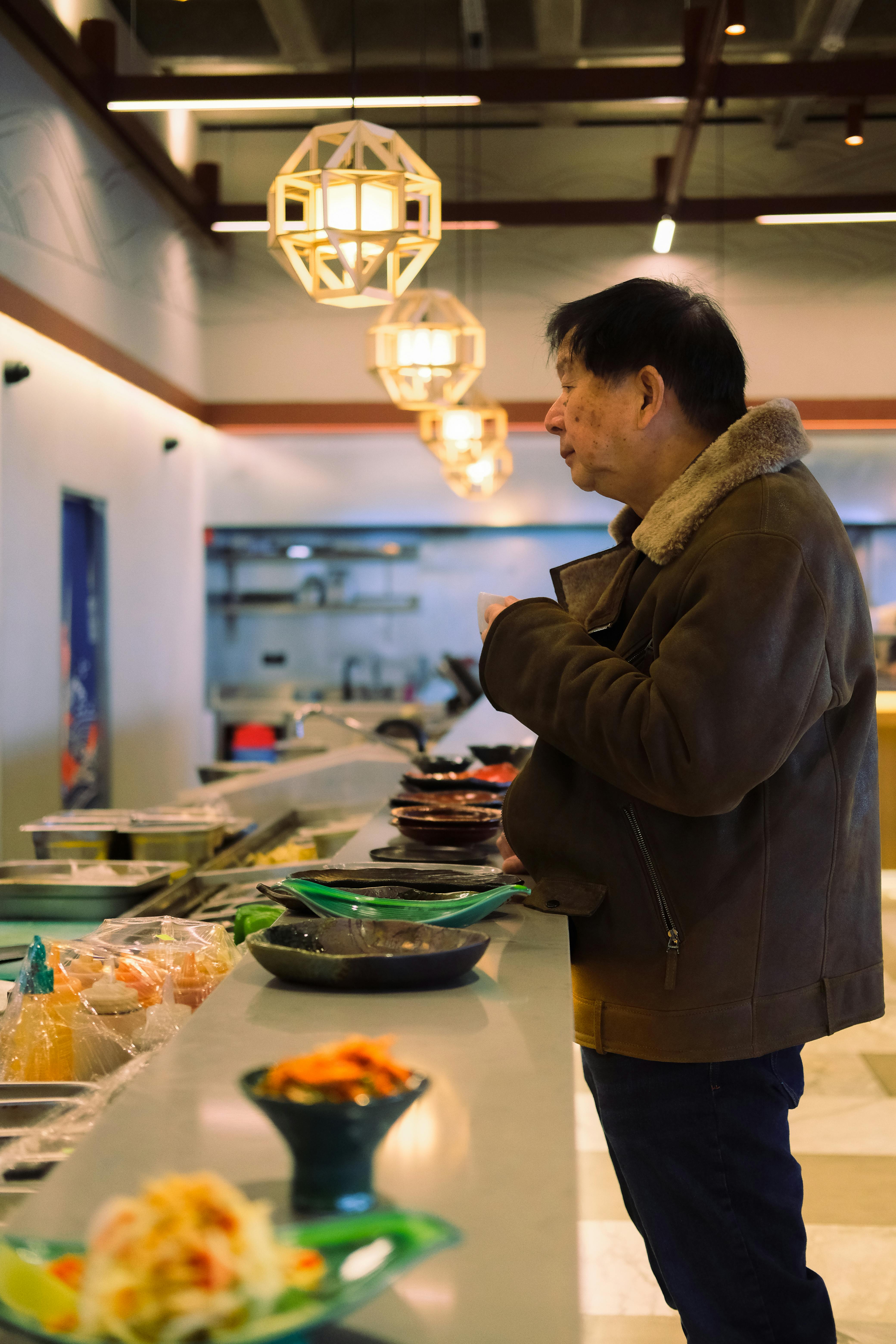 man standing by table in restaurant