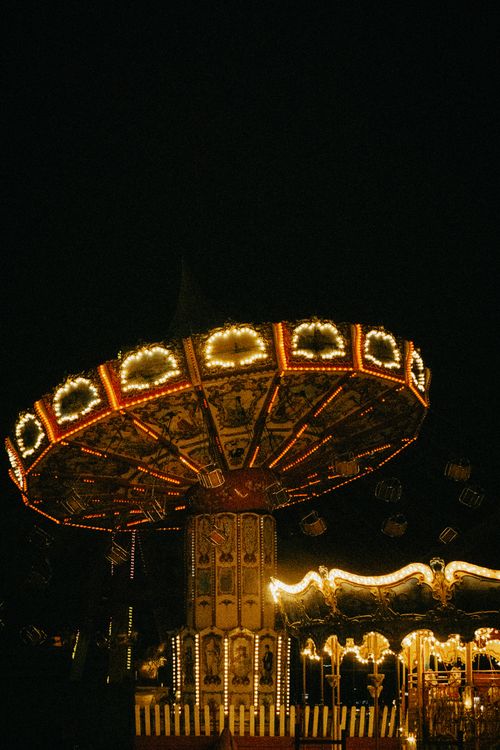 Free A colorful carnival swing ride illuminated against a dark night sky, capturing vibrant lights and festive ambiance. Stock Photo