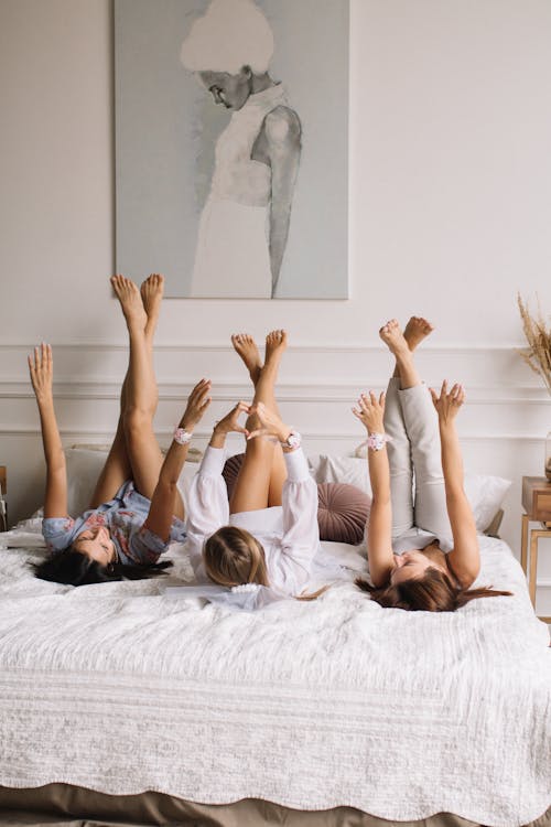 Women Lying on Bed 