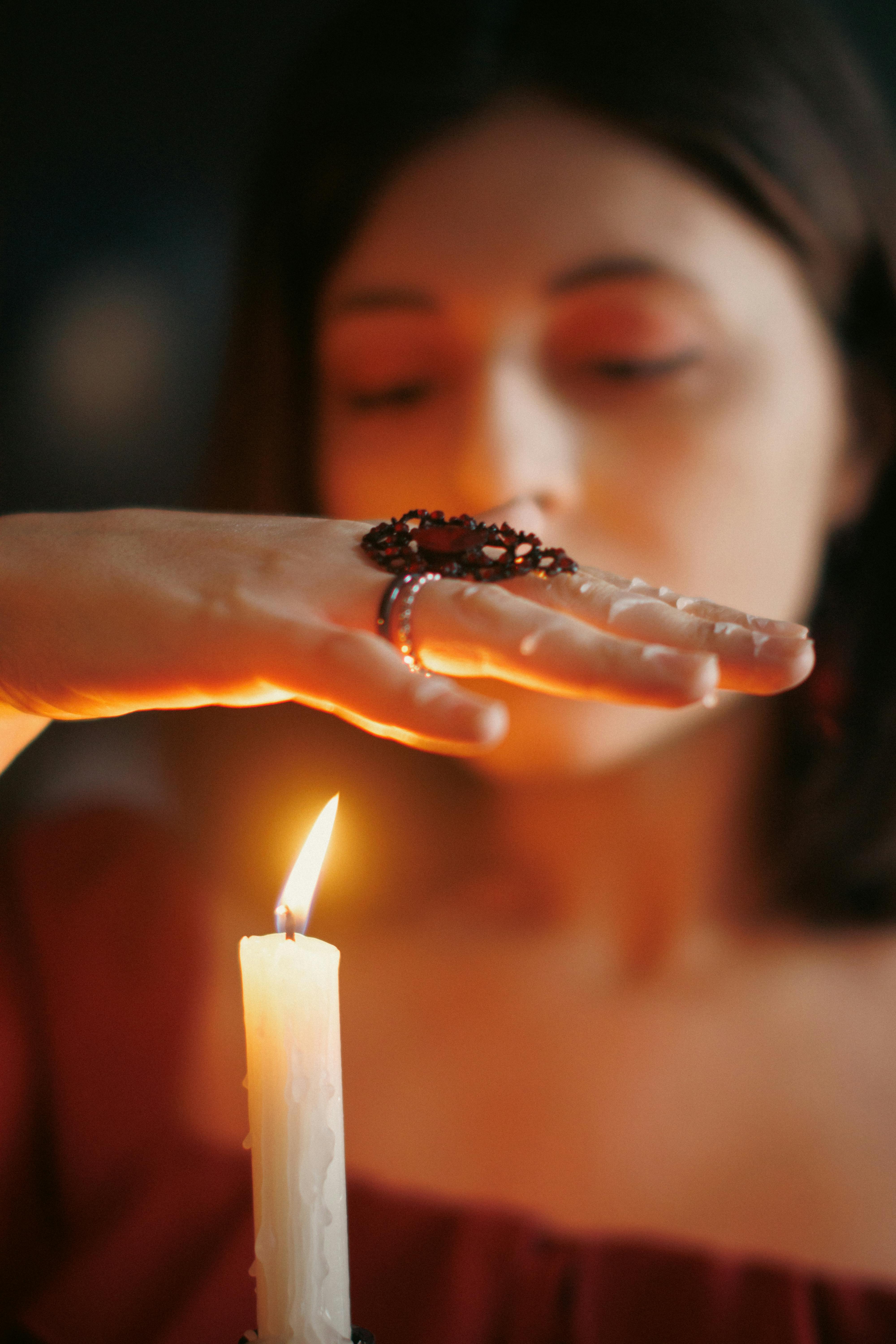 DIY wax candle making process. Woman lights decorative wax candle, close-up  of hands - Stock Image - Everypixel