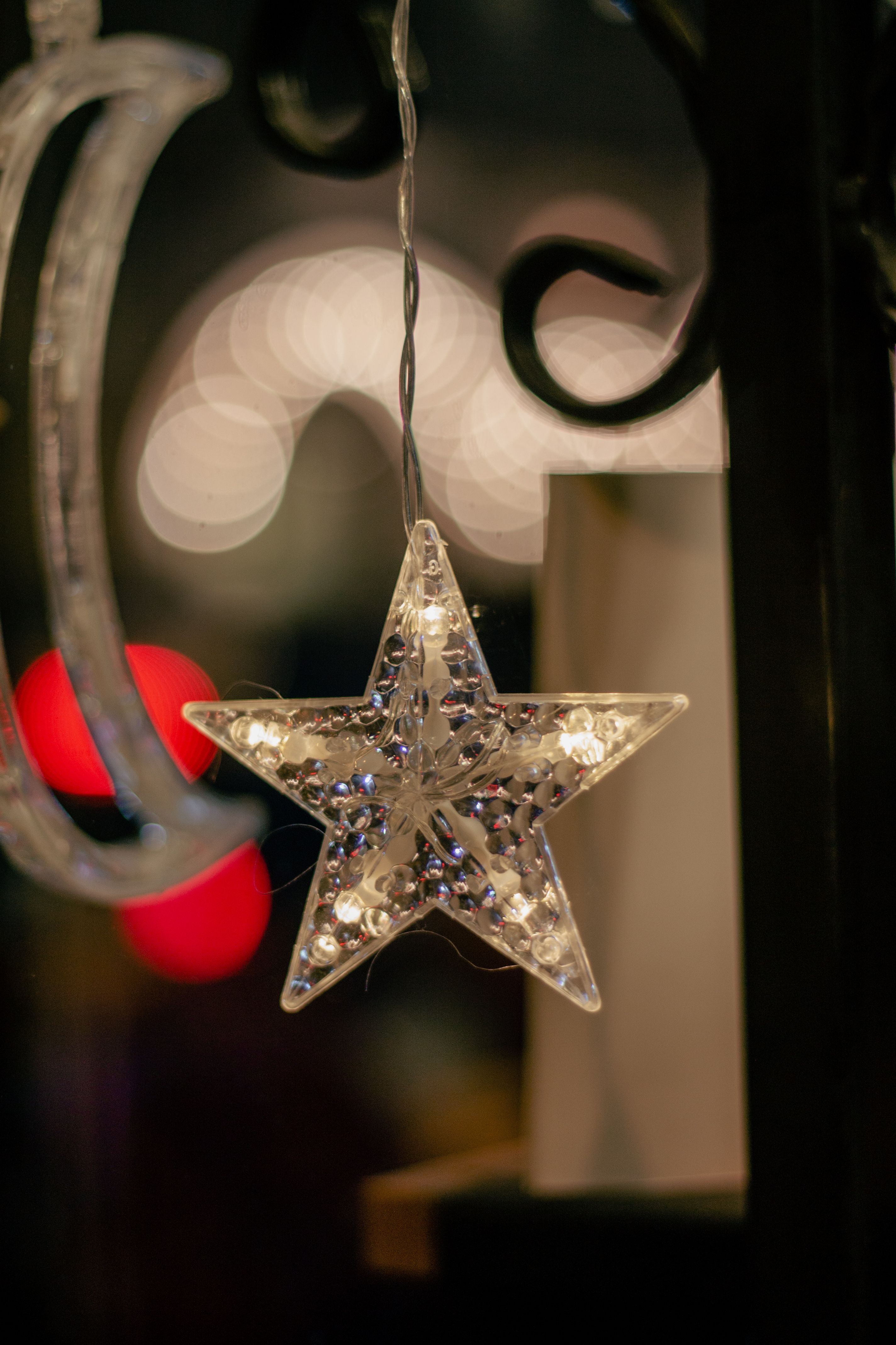 Close-up of a sparkling star ornament hanging against a blurred background in Istanbul.