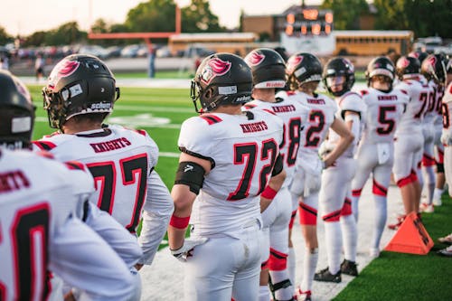 American Football Players in Row in Stadium