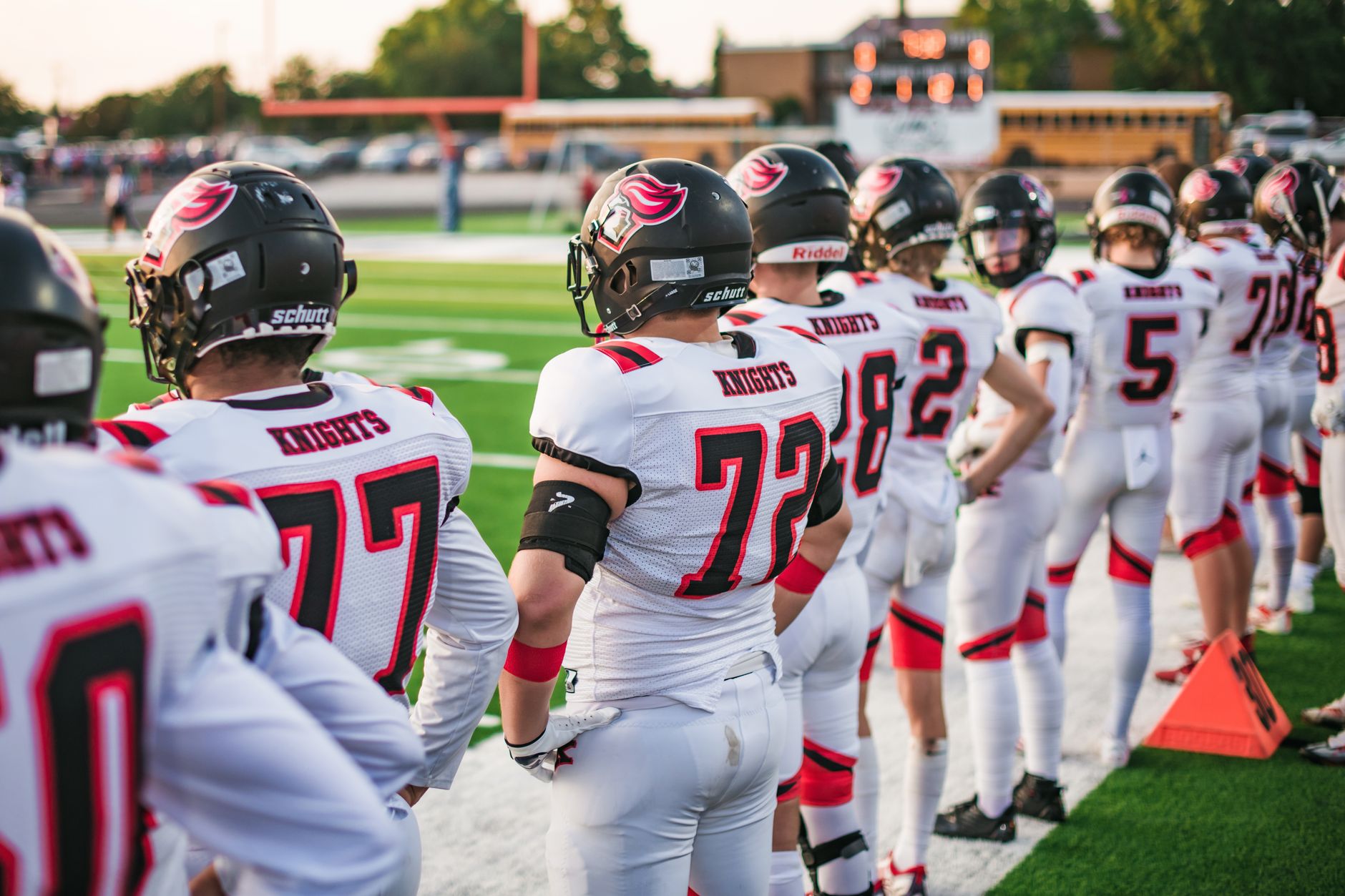 High school football players in white uniforms preparing for a game in Idaho Falls.