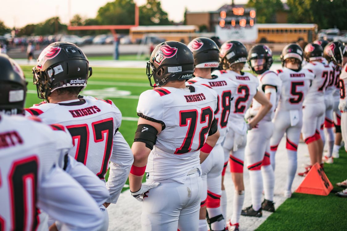 Free High school football players in white uniforms preparing for a game in Idaho Falls. Stock Photo