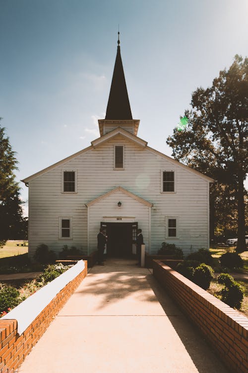 Free Two Person Standing Near White Church Stock Photo